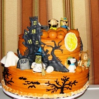 Charlie Brown Great Pumpkin figures are fondant, houses are color flow and trees are piped buttercream