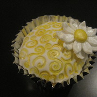 Daisy Cupcake Cupcake covered with fondant and decorated with fondant daisy and luster dust.