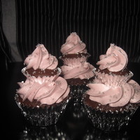 Tiered Cupcake Tiered chocolate cupcakes with raspberry icing and silver sugar crystals.