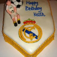 Real Madrid - Soccer Cake - Made For A Raul Fan Chocolate cake with buttercream frosting, covered in MMF. The soccer ball is a chocolate cake too covered in MMF and hand painted. The...