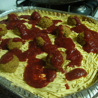 Spaghetti Cake Cream cheese frosting with cake meatballs and strawberry sauce