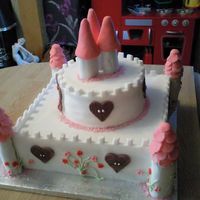 Princess Castle Cake Made for my cousins baby girls christening. Bottom tier is madeira and top is chocolate cake. ALl covered with fondant. I made the towers...