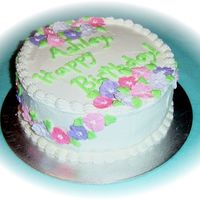 Floral Birthday Cake A 9 inch round, white cake with raspberry filling. Iced with buttercream, RI flowers. Thanks for looking!