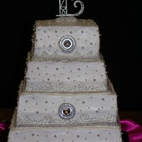 Princess Wedding Cake Each tier has a layer of strawberry and a layer of coconut cake. Buttercream icing with dragee accents.