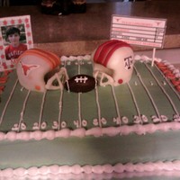Longhorns Vs. Aggies My stepson loves the Longhorns and wanted them against the Aggies.Vanilla cake with buttercream icing. The helmets are rice crispy treats...