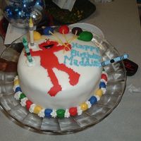 Elmo's Balloons This is my first fondant cake. I had some color bleeding but other than that I was satisfied. This was made for my grandgirl.