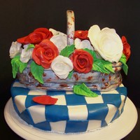 Mom's First Bloom Vanilla cake with homemade gumpaste roses and accents. With a rusted bucket in fondant. Thanks for looking.