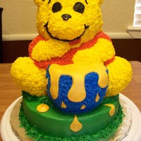 Winnie The Pooh Bear cake pan, a couple of modifications. Frosting is butter cream. Honey is made out of fondant.