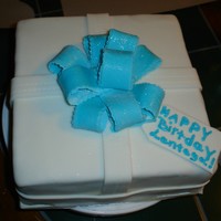 Birthday Present This yellow butter cake is three layers filled with white chocolate buttercream icing between each layer. The cake is covered with vanilla...