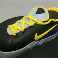 Nike Shoe This was my first attempt at a shoe cake. I Carved the shoe, crumb coated and covered in black fondant, then did the details in fondant.