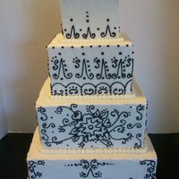 Black & White Scroll buttercream covered 10" 8" 6" & 4". Scroll work done with Royal Icing.