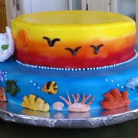 Sea And Sky Luau cake for a party at my son's school. air brushed over fondant, with hand made fondant Gardenia's.