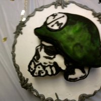 Metal Mulisha round cake with 3d carved skull on top, hand painted on fondant