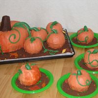 Pumpkin Patch Choc. sheet cake covered in crushed choc. cookies, Pumpkins are butter cake with buttercream icing and fondant accents.