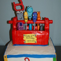 Handy Manny Birthday Cake Handy Manny Birthday Cake. Base is half yellow/half chocolate with chocolate mouse filling and almond butter cream. Accents are foundant....