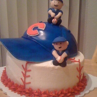 Chicago Cubs Cake Lower part is a 8 in vanilla cake covered in buttercream. For the hat I used one part of the ball pan and covered it with fondant. the bill...