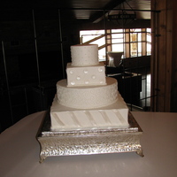 Shiny Polka Dots And Stripes Wedding Cake BC with fondant polka dots and diagonal stripes painted with pearl dust.