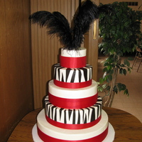 Red Zebra BC with fondant zebra stripes, purchased satin ribbon and plumes. Vanilla/Almond cake with raspberry filling. Delivered 90 miles away--no...