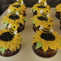 Mothers_Day_Cupcakes_003.jpg Mother's Day chocolate cupcakes, with creme' filling and buttercream sunflower on top. Decorative cupcake bee inserted. First...