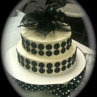 Polka Dots BC icing with black satin ice fondant dots. The topper was a corsage of mine that I used flower wire to make a stem and stuck in a straw. I...