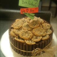 Barrel Of Cookies Here is my twist on the Barrel cake. Chocolate cake filled with vanilla custard and frosted with chocolate icing. KitKats border the cake...