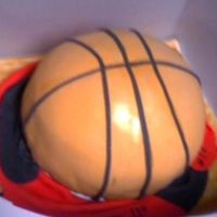 Basketball Cake The basketball cake was carved from 3 9-inch layers and covered in fondant and fondant accents. The board underneath is painted with brown/...