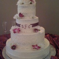 Sharon's Wedding Cake 2nd and bottom tiers are french vanilla w/raspberry filling, top and 3rd tiers are chocolate with mocha buttercream filling, all iced in...