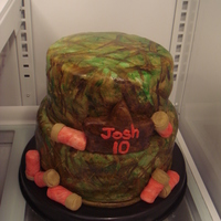 Hunting Hunting cake. Hand painted camo on white marshmallow fondant. Shot guns shells(not my best) krispy bars rolled and covered.