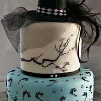Top Hat And Feathers This cake was made for the grand opening of a local spa. Lemon sour cream cake underneath w/ white chocolate BC and fondant on top. The...