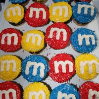 M & M Cupcakes Marble cupcakes with buttercream icing and coloured sprinkles....I used tip 147 to do the "m".