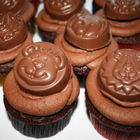 Chocolate Cupcake Chocolate cupcakes with chocolate buttercream icing. The medallions are made from a mold and the inside is a oreo cookie