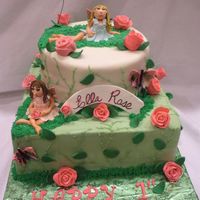 Fairy And Roses Cake this was a 2 tiered first birthday cake with a roses and fairies theme...The roses as well as the fairies and butterflies were all made...