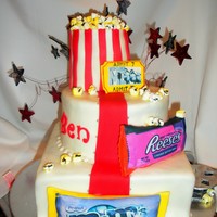 A Day At The Movies Movie theatre cake...popcorn box is RKT filled with marshmallows cut, painted and airbrushed to look like popcorn, candy is fondant covered...