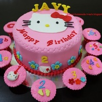 Hello Kitty Birthday Cake 8" Hello Kitty themed cake with alphanumerics cupcakes. All decorations are made of fondant/gumpaste. TFL