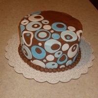 Brown And Blue Circles This was for my god-daughter. Chocolate cake with chocolate gananche filling. Covered in Chocolate Buttercream and fondant circles.