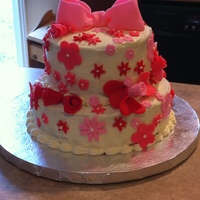Tiered Flowers Cake My 11 years old wanted a tiered cake, so this was my attempt at it. Covered in French Buttercream and decoratations are fondant.