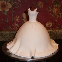 3D Wedding Dress Cake Almond cake cover in fondant and decorated with sanding sugar and royal icing. I made this for my futuer sister in law.