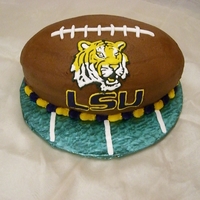 Football Cake My son's 8th birthday! He loves LSU so he asked for a football cake. Chocolate cake with chocolate frosting. Royal icing for the tiger...