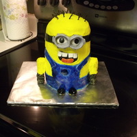 Despicable Me Minion 6 in tiers for body. with buttercream frosting/yellow. Fondant outfit. glasses fondant/gumpaste. Hair licorice. arms RKT with frosting over...