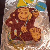 Monkey Birthday Cake This monkey was made from the Wilton mold and I used vanilla and chocolate buttercream icing. The hat and balloons were made out of fondant...