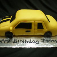 Bubblebee Birthday Cake A car shaped white cake with lemon frosting covered and decorated with fondant.