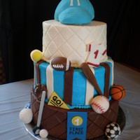 Sports Theme Baby Shower Cake Three tier yellow butter cake with strawberry, vanilla, and chocolate frosting.