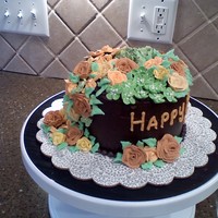 Fall Colored Flowers Chocolate Cake 2 - 6 inch layers, filled with buttercream, iced with buttercream tinted brown. The flowers are made of Royal Icing, it was...