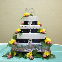 Square Fondant Covered Wedding Cake 7 in, 10 in, 14 inch square french vanilla cakes, buttercream filling and fondant covered using fondx brand. The middle layer is quilted....