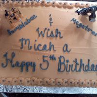 Transformers This is a yellow cake with buttercream icing. I used action figures of Transformers. TYFL!