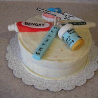 Old Age Necessaties French vanilla cake with an orange cream cheese frosting. All accent pieces are fondant. Spinner arrow just push pinned into a dowel in the...