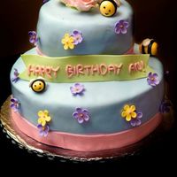 First Birthday Cake Yellow cake with milo whipped cream filling.All fondant decorations.