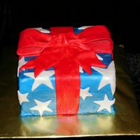 Patrick's Homecoming Cake The cake I made for my husband's return from Iraq. It is a fondant covered cake painted with luster dust. The bow is gumpaste.