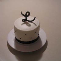 6" Sample Cake Black W/ Diamond And Initial 6" Choc Fudge/WASC with Choc. Fudge Filling, butter cream with diamond imprint and black dots, Fondant Initial, black ribbon.