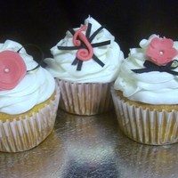 Pink & Black Birthday Cupcakes White chocolate chip cupcakes with white chocolate buttercream in three different designs. Fondant flowers with gross grain ribbon.